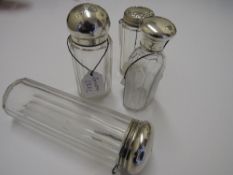 4 various glass dressing table pots with silver lids, London 1931, 1881, 1912 & 1919. Estimate £30-