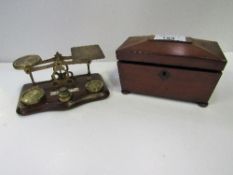 Small rosewood tea caddy & a set of postal scales. Estimate £40-60.