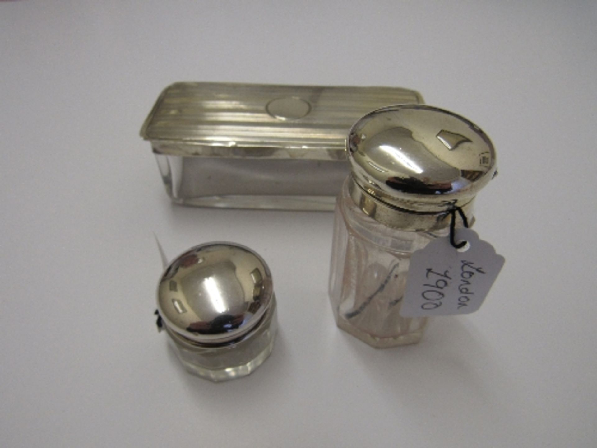 Rectangular glass dressing table pot with silver lid, Birmingham 1939; a small circular pot with