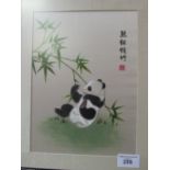 Framed & glazed oriental silk picture of a panda. Estimate £15-25.