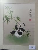 Framed & glazed oriental silk picture of a panda. Estimate £15-25.