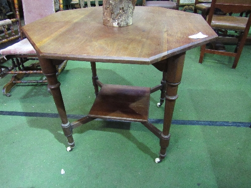 Mahogany octagonal top display table on castors. Estimate £25-40.