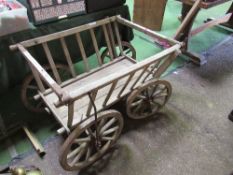 Small 4 wheel hand cart on metal tyred spoked wheels with railed sides. Estimate £50-80.