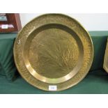 4 large brass trays. Estimate £30-40.