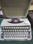 Vintage Olympia Splendid 66 cream coloured portable typewriter with cover. Estimate £10-20.