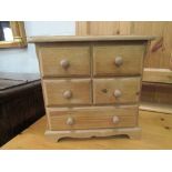 Miniature chest of 2 over 1 drawers. Estimate £20-30.