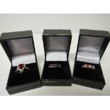 3 lady's sterling silver rings (red stones). Estimate £28-35.