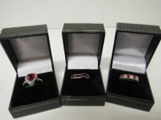 3 lady's sterling silver rings (red stones). Estimate £28-35.