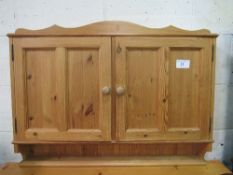 Pine hanging wall cupboard with interior shelf, 96.5cms x 13cms x 72cms. Estimate £20-30.