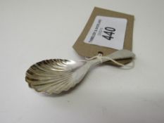 Silver scallop shaped tea caddy spoon by James Swan & Son, Birmingham 1929. Estimate £20-30.