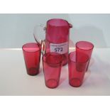 4 cranberry tumblers & a cranberry water jug. Estimate £10-20.