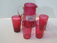 4 cranberry tumblers & a cranberry water jug. Estimate £10-20.