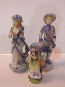 2 blue & white figurines & a female figurine with a bird. Estimate £15-20.