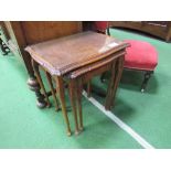Nest of 3 walnut tables with glass tops. Estimate £10-20.