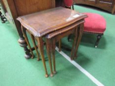 Nest of 3 walnut tables with glass tops. Estimate £10-20.