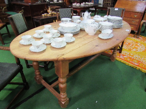 Drop-leaf oval shaped pine table on turned supports & stretcher, 200cms x 117cms (max) x 78cms.