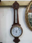 Decorative wall hanging aneroid barometer & thermometer (glass cracked). Estimate £20-40.