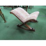 An upholstered oak framed child's rocking chair. Estimate £20-30.