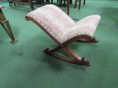 An upholstered oak framed child's rocking chair. Estimate £20-30.