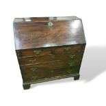 Oak bureau with 2 over 3 drawers, brass plate handles & escutcheons standing on bracket feet,
