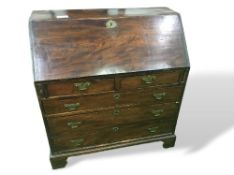 Oak bureau with 2 over 3 drawers, brass plate handles & escutcheons standing on bracket feet,