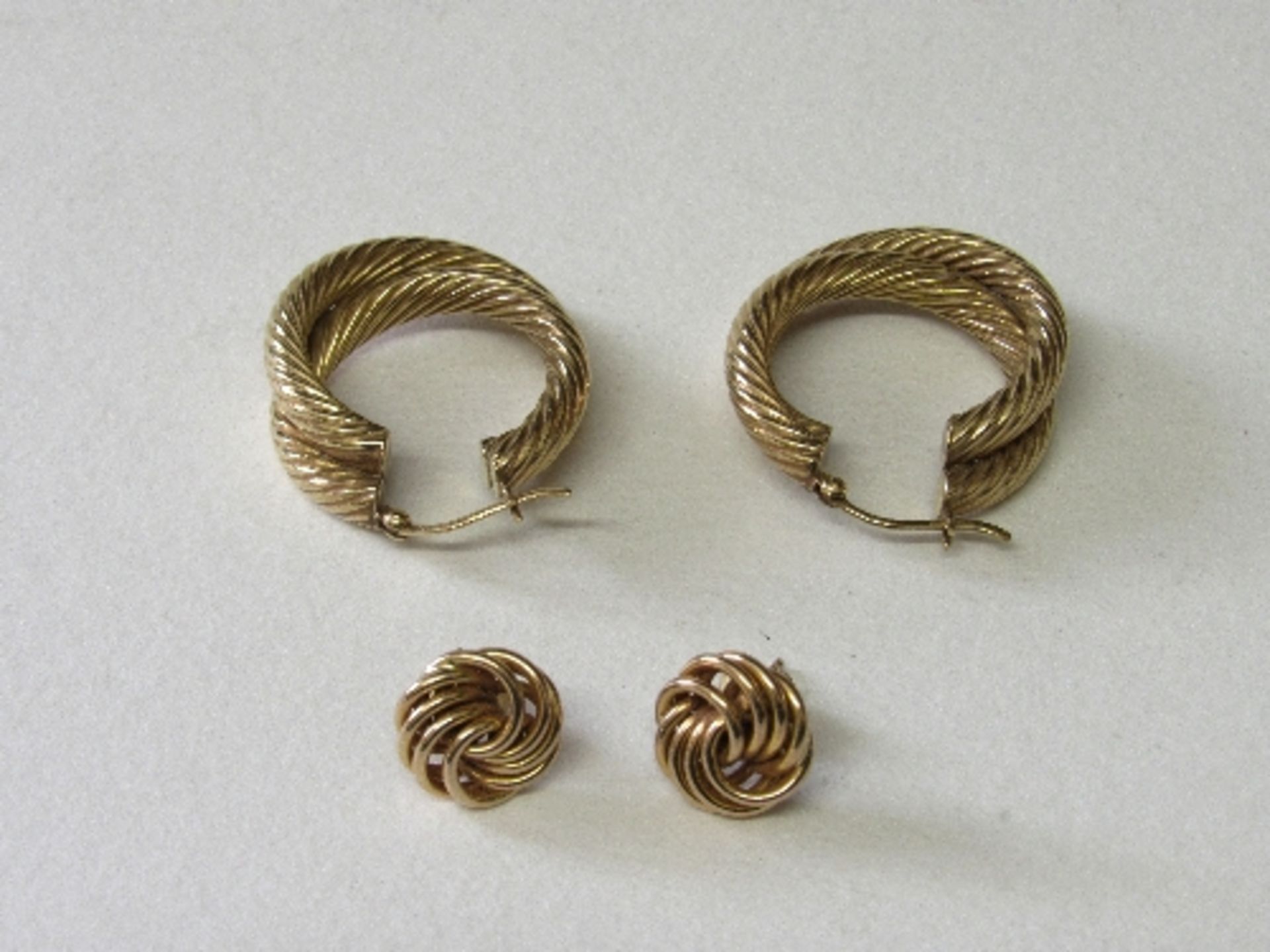 Pair of 9ct gold twisted loop earrings & a pair of 9ct gold knot earrings, total wt 6.8gms. Estimate