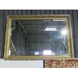 Rectangular decorative gilt framed bevel-edged mirror by Morris Mirrors, 72cms x 100cms. Estimate £