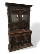 Magnificent Victorian carved oak library display cabinet with carved panels to the doors featuring