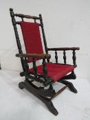 Child's turned oak rocking chair, 71cms high. Estimate £20-40.