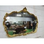 Ornate, carved gilt framed decorative wall mirror, 120cms x 90cms. Estimate £40-60.