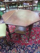 Mahogany octagonal top display table on castors. Estimate £25-40.