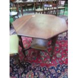 Mahogany octagonal top display table on castors. Estimate £25-40.