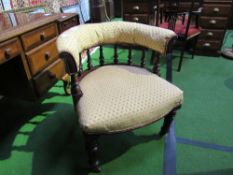 Gold upholstered Captain's spindle back chair, on castors. Estimate £30-50.