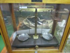 A set of Griffin & Tatlock precision scales in glass & wood case c/w 2 sets of weights. Estimate £