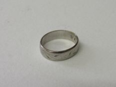 Platinum band with engraved decoration, size K, wt 5gms. Estimate £60-80.