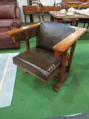 Tiger oak metamorphic library table, converts to a library armchair. Estimate £120-150.