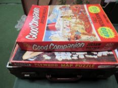 Vintage child's suitcase containing Victory jigsaws, picture blocks, film strips with view, tin-