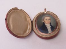 Miniature oil portrait of a late 18th/19th century gentleman in blue frock coat, in original case,