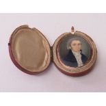 Miniature oil portrait of a late 18th/19th century gentleman in blue frock coat, in original case,