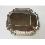 A silver tray with indented corners & 4 scroll feet by Mappin & Webb, Sheffield, 1940, 31ozt.