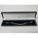 Sterling silver tennis bracelet. Estimate £20-30.