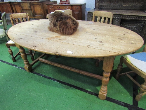 Drop-leaf oval shaped pine table on turned supports & stretcher, 200cms x 117cms (max) x 78cms.