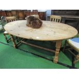 Drop-leaf oval shaped pine table on turned supports & stretcher, 200cms x 117cms (max) x 78cms.