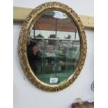 Oval pierced gilt framed bevel-edged wall mirror. Estimate £20-30.