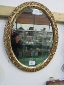 Oval pierced gilt framed bevel-edged wall mirror. Estimate £20-30.