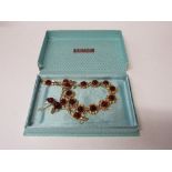 A 1950's gold coloured rose decorated jewellery set in H Samuel box. Estimate £5-10.