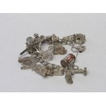 Silver charm bracelet with 21 charms, some of which are silver marked & 1 other charm. Total