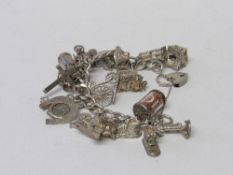 Silver charm bracelet with 21 charms, some of which are silver marked & 1 other charm. Total