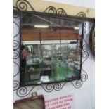 Wrought iron framed wall mirror. Estimate £12-18.