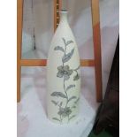 Tall cream coloured ceramic bottle/vase decorated with flowers, height 64cms. Estimate £10-20.